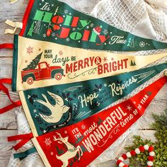 three christmas pennants with holiday sayings on them