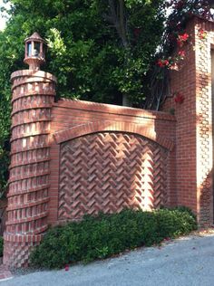a red brick gate with a clock on it