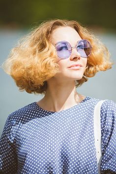 a woman with blonde hair wearing sunglasses