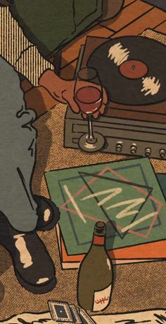a person sitting at a table with a record player and wine glass in front of them