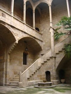 an old building with stone stairs and arches