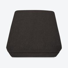 a black square ottoman cushion on a white background, with the bottom section facing away from the camera