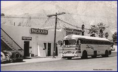 an old school bus parked in front of a building