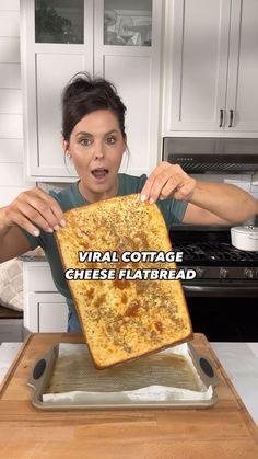 a woman holding up a piece of bread with the words virtual cottage cheese flatbread on it