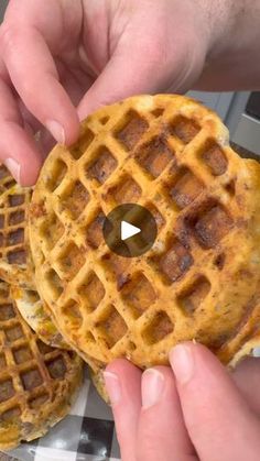 two waffles being held up to the camera