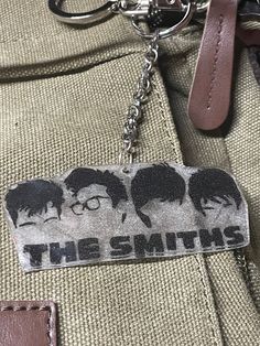 the smiths keychain is hanging from a bag