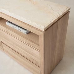 a white marble top on a wooden cabinet