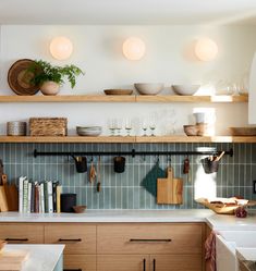 the kitchen is clean and ready for us to use it's counter tops are neatly organized