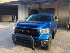 a blue truck parked in front of a building