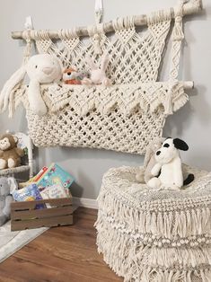 a white wicker hammock with stuffed animals on it in a child's room