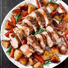 a white plate topped with meat, potatoes and carrots