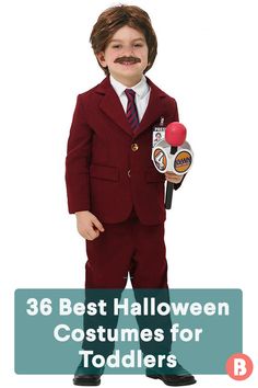 a little boy dressed in a suit and tie with fake mustaches on his face