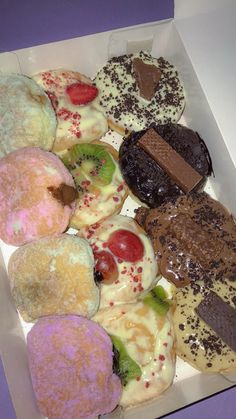 a box filled with lots of different flavored donuts