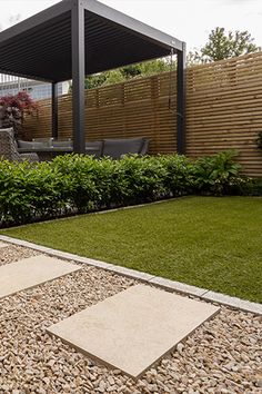 an outdoor living area with grass and rocks