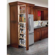 a kitchen with wooden cabinets and stainless steel refrigerator freezer next to an open pantry door
