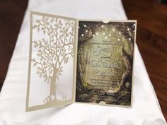 an open card with a tree on it and some lights in the trees behind it