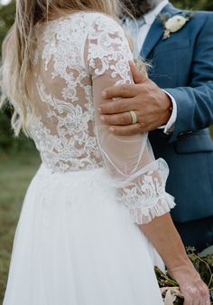 the bride and groom are holding each other close together