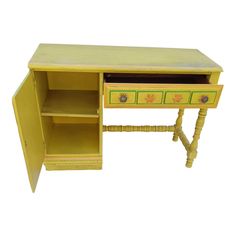 a small yellow desk with drawers on the bottom and one drawer open to reveal an item