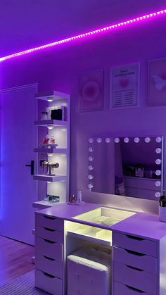 a room with purple lighting and a vanity in the corner, there is a mirror on the wall