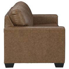 a brown leather couch sitting on top of a wooden table