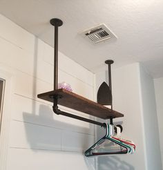 Hanging Pipe shelf. Made from plumbing pipe from home depot. Small Laundry Room Hanging Ideas, Laundry Shelf Ideas, Hide Sump Pump In Basement, Laundry Hanging Ideas, Coat Hanging Ideas, Laundryroom/mudroom Ideas, Garage Laundry Area Ideas, Garage Laundry Area, Laundry Remodel