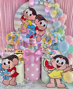 a birthday party with cartoon characters on the table and balloons in the air behind it