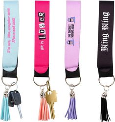 three lanyards with keychains attached to them, one is pink, the other is blue