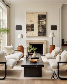 a living room filled with furniture and a painting on the wall above it's fireplace