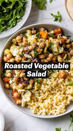 a white bowl filled with rice, chickpeas and vegetables on top of a table