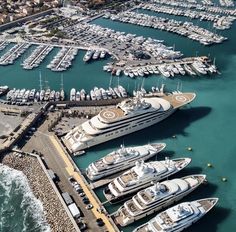 an aerial view of several boats docked in the water at a marina with many other boats