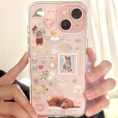 a person holding up a cell phone case with stickers on it and an image of a dog