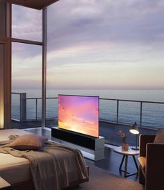 a bedroom with a large window overlooking the ocean