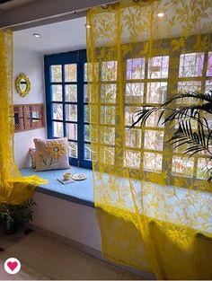 a yellow curtain is hanging in front of a window