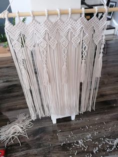 a close up of a piece of string art on a wooden floor next to scissors