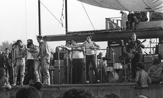 a group of people standing on top of a stage next to each other in front of a crowd