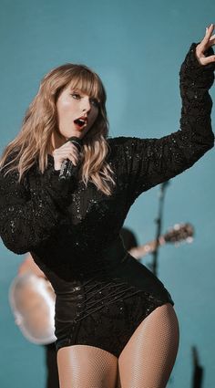 taylor swift performing on stage at the concert
