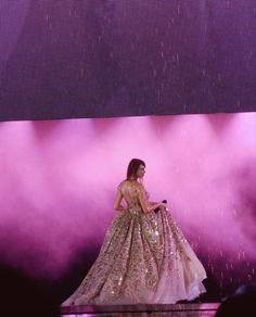 a woman in a long dress on stage