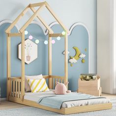 a child's bed with a wooden frame and canopy over the top, in a blue room