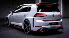 the rear end of a white volkswagen golf gtr with red stripes and black rims