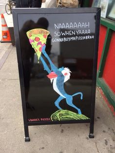 a sign on the sidewalk advertising pizza