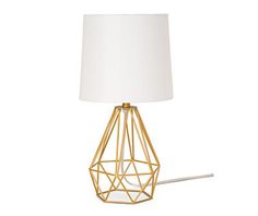 a gold metal table lamp with a white shade on the base and a light bulb attached to it