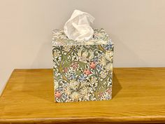 This gorgeous William Morris Golden Lily decoupaged tissue box cover is perfect for storing your tissues neatly and discreetly .  The box has been hand painted and then decoupaged using the napkin technique before being protected  with three layers of matt varnish . A lovely addition to any room and would also make a great gift.   Each tissue box comes complete with a box of tissues. Measurements approx 13.2cm square 7mm thick MDF For a wide selection of handcrafted tissue box covers please clic William Morris, Tissue Box Holder, Tissue Box Cover, Box Storage, Tissue Box Covers, Tissue Box, Covered Boxes, Tissue Boxes, Storage Boxes