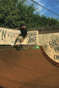 a man riding a skateboard up the side of a ramp at a skate park