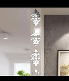 the wall is decorated with decorative designs and lights in white, grey and black colors