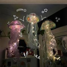three jellyfish lights hanging from the ceiling