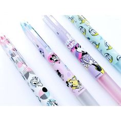 three pens with different designs on them sitting next to each other