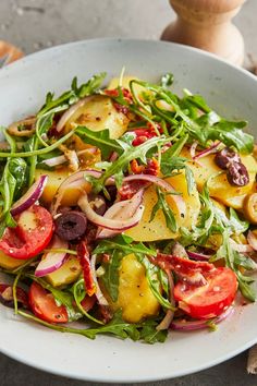 a white bowl filled with lots of veggies