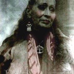 an old photograph of a woman with long hair