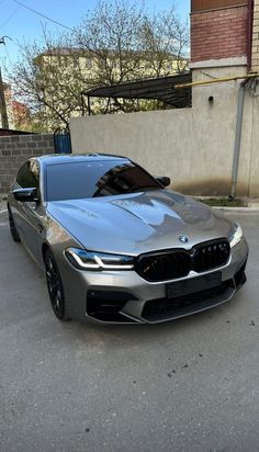 a silver car parked in front of a building