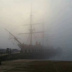 a large boat in the water on a foggy day